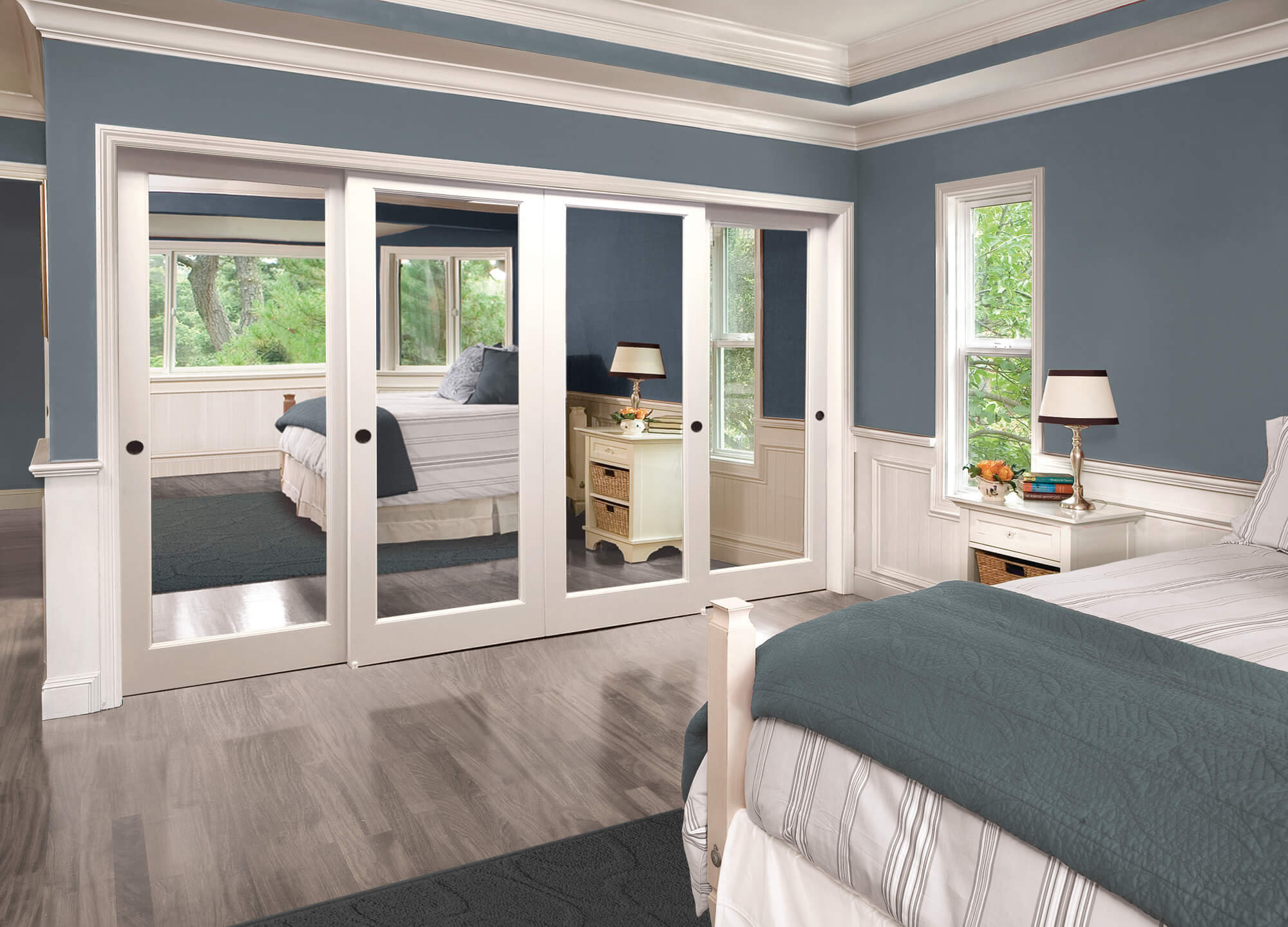 Bedroom with elegant white mirrored sliding closet doors
