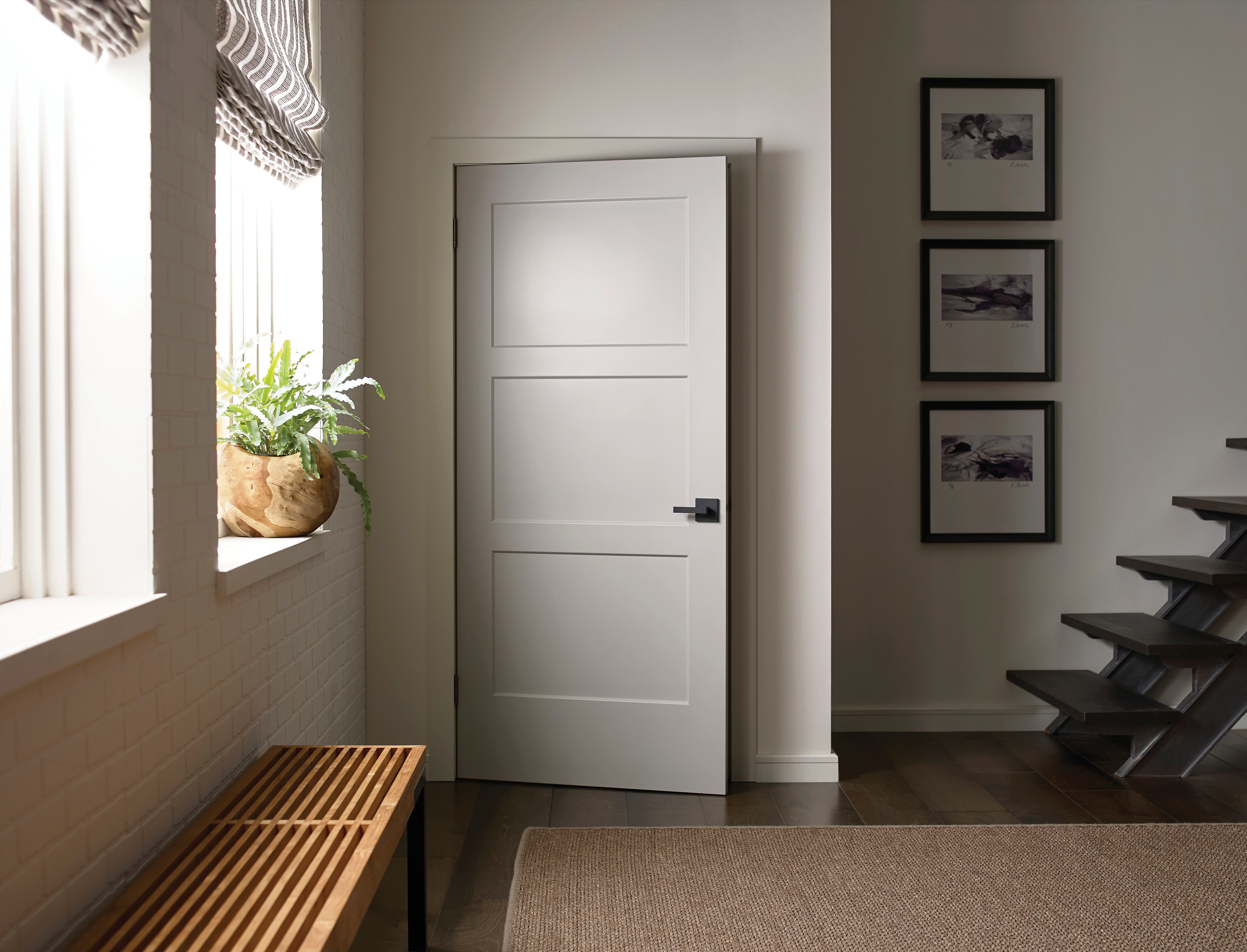 Entryway with white Chelsea shaker door and natural light