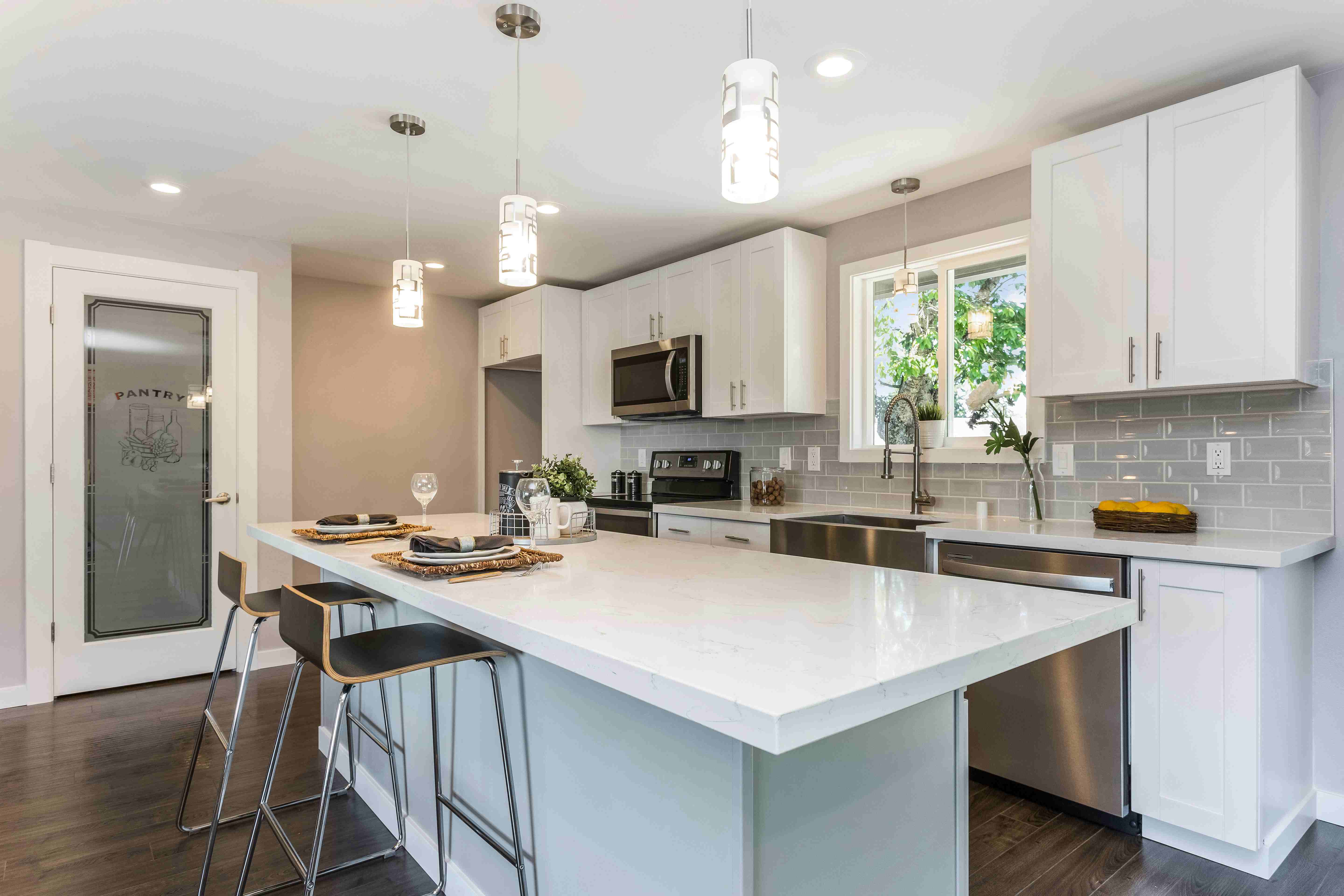 Modern kitchen with elegant white pantry door with glass panel